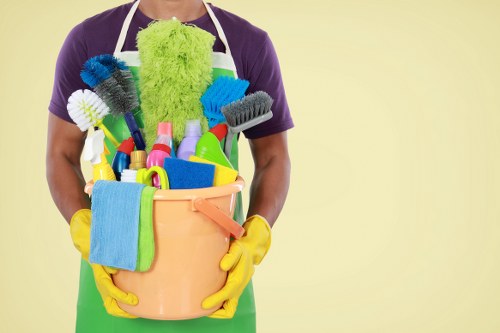 Carpet cleaning technician preparing equipment with safety precautions in Edgware