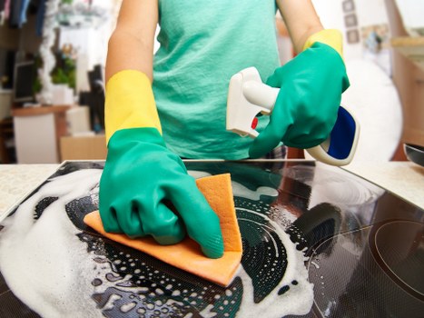 Cleaner working on a carpeted area with safety precautions